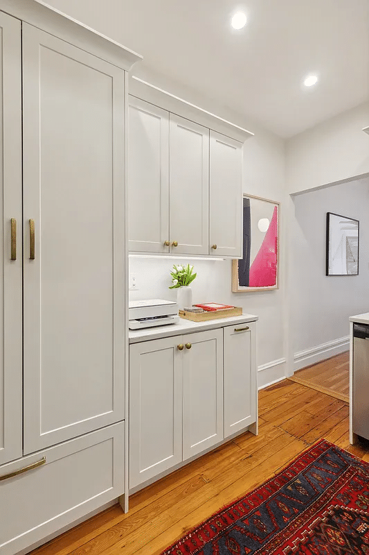 kitchen with white cabinets, wood floor