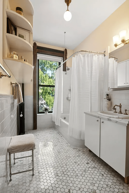 bathroom with tub, hex floor tile