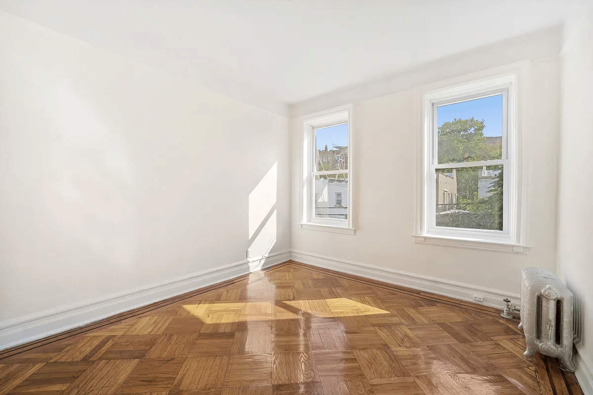 bedroom with two windows, wood floor