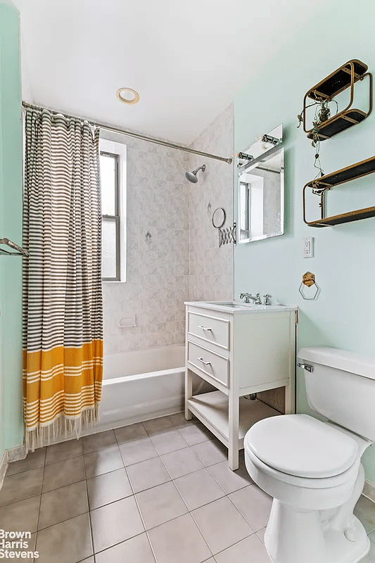 bathroom with white fixtures, beige tile floor