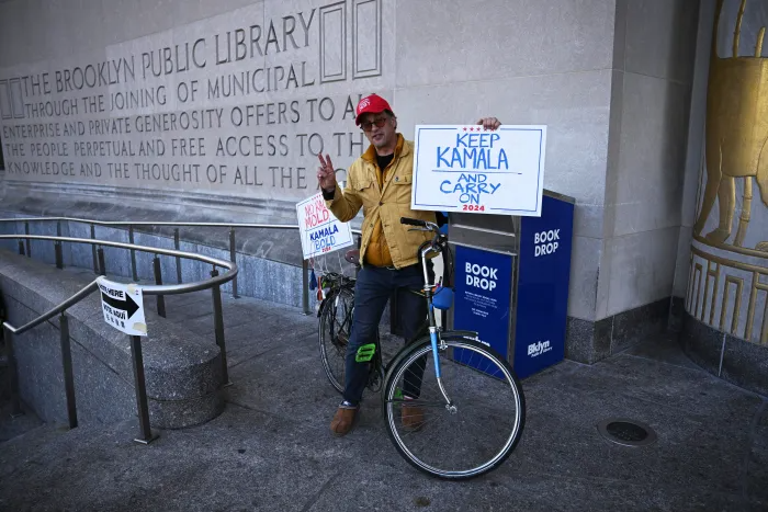 A voter near the Brooklyn Public Library’s Central Branch encourages locals to ‘keep Kamala and carry on.’