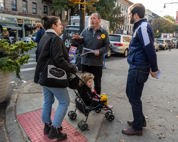 Comptroller Brad Lander and state Sen. Andrew Gounardes talk to a voter outside M.S. 51 in Park Slope.