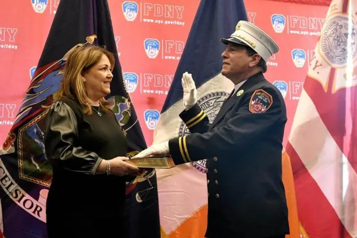 Monsignor Jamie Gigantiello, then-pastor of Our Lady of Mount Carmel and Annunciation of the Blessed Virgin Mary in Williamsburg, being sworn in by his sister, Toniann Martello as chaplain for the New York City Fire Department in February 2022.