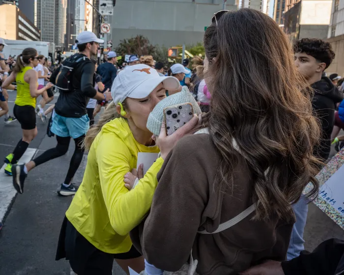 a runner kissing a baby