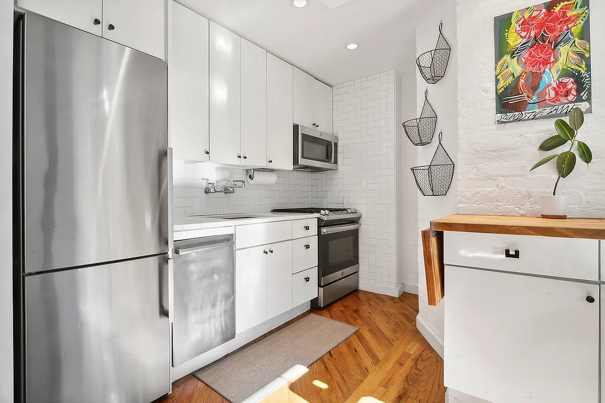 kitchen with white cabinets and stainless steel appliances, including a dishwasher