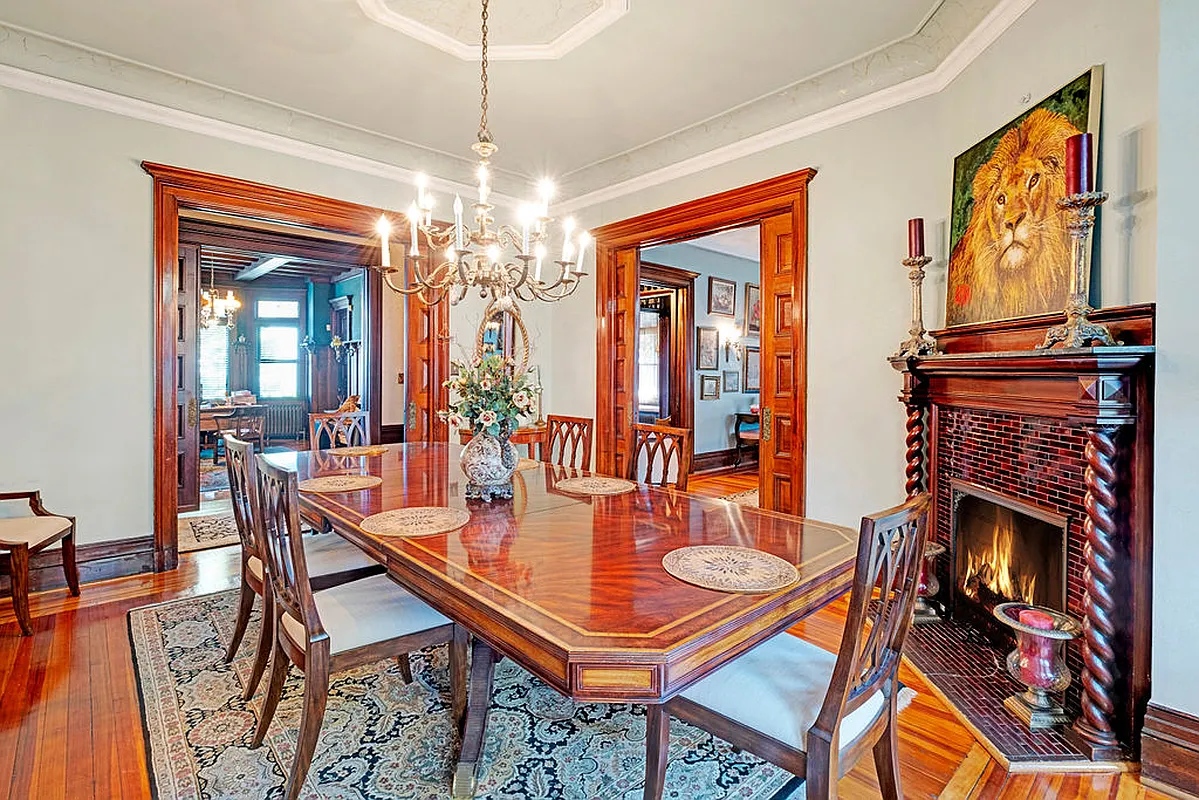 living room set up as a dining room with corner mantel with twisted columns