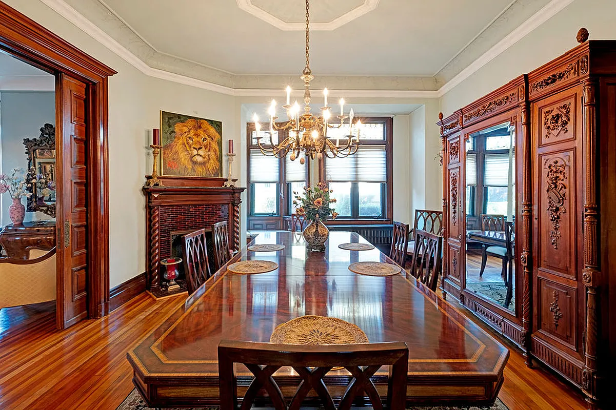 living room set up as a dining room with pocket doors, corner mantel