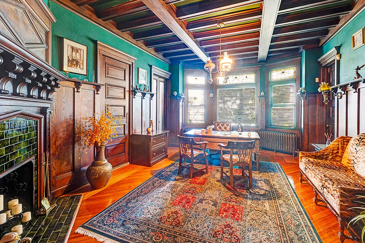 original dining room with wainscoting, plate shelf, mantel, beamed ceiling