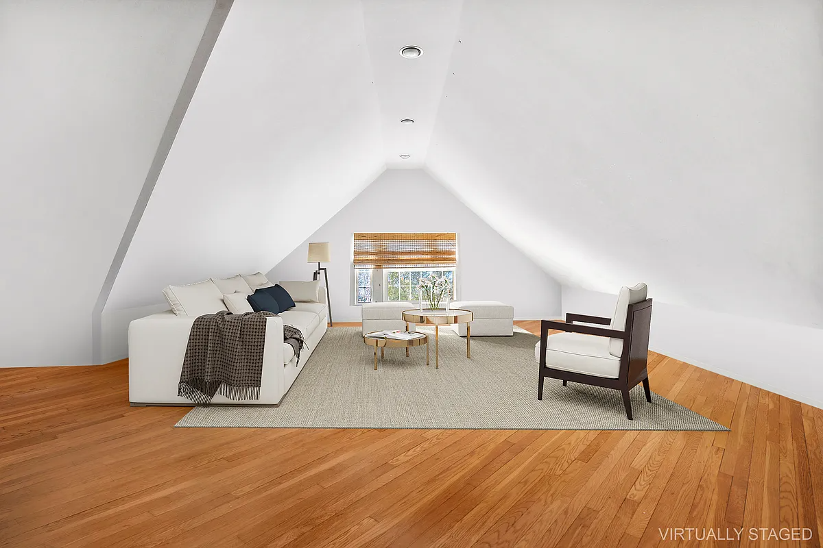 virtually staged attic level shown as a seating area