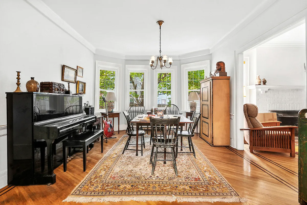 dining room with wood floor, bay window