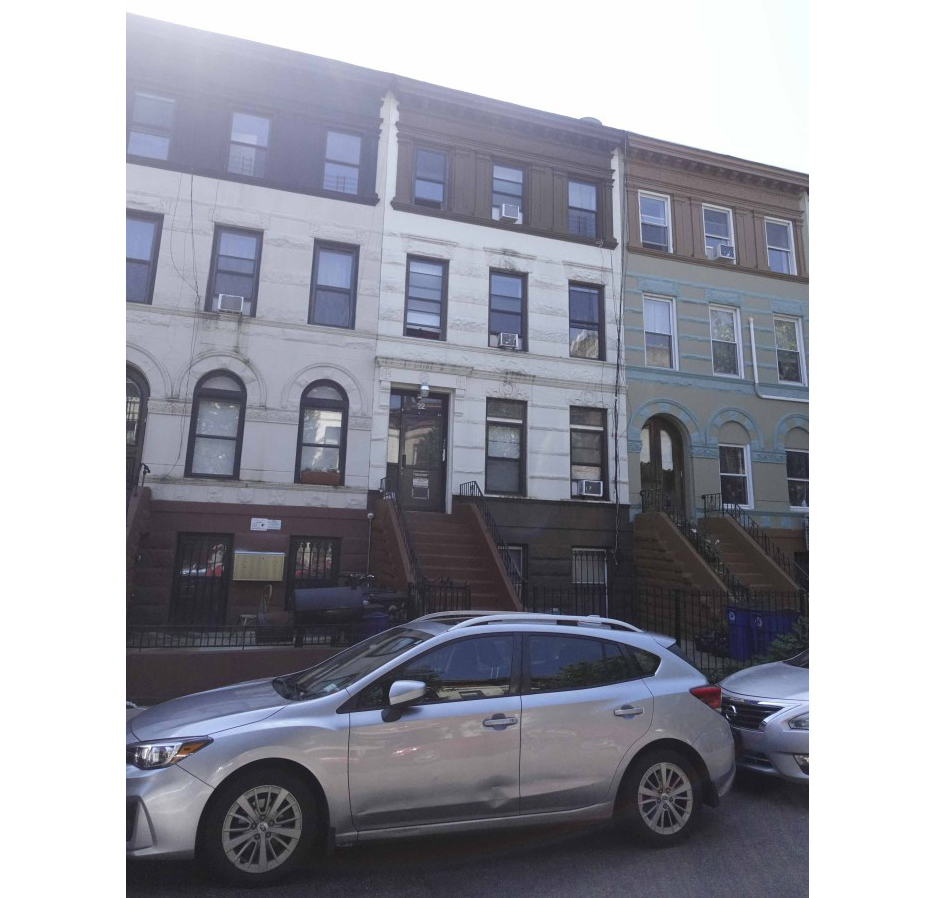 row house with stoop and a painted facade