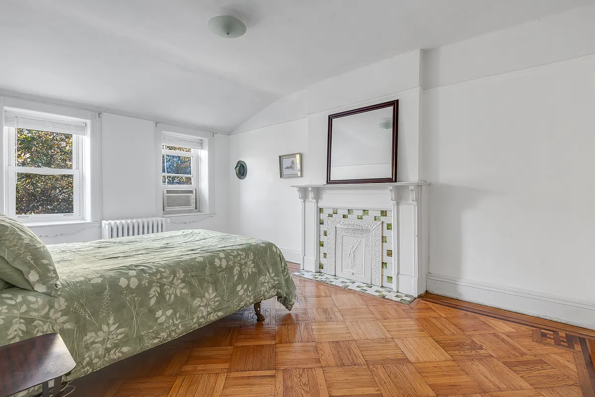 bedroom with white painted mantel