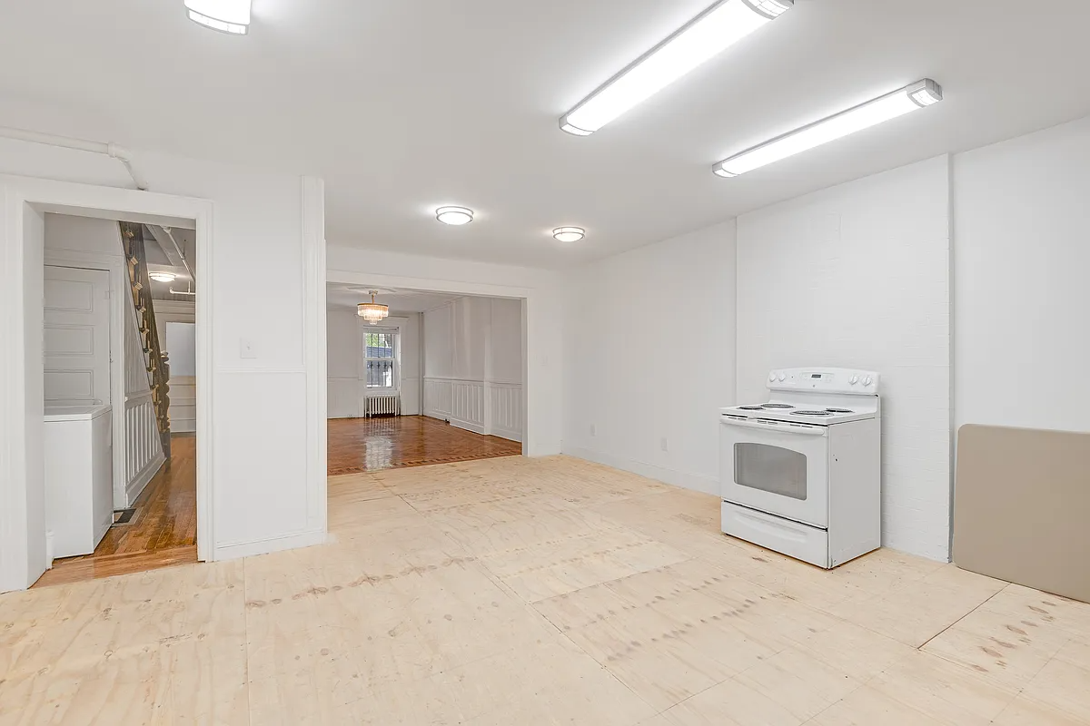 unfinished kitchen on garden level with plywood floor