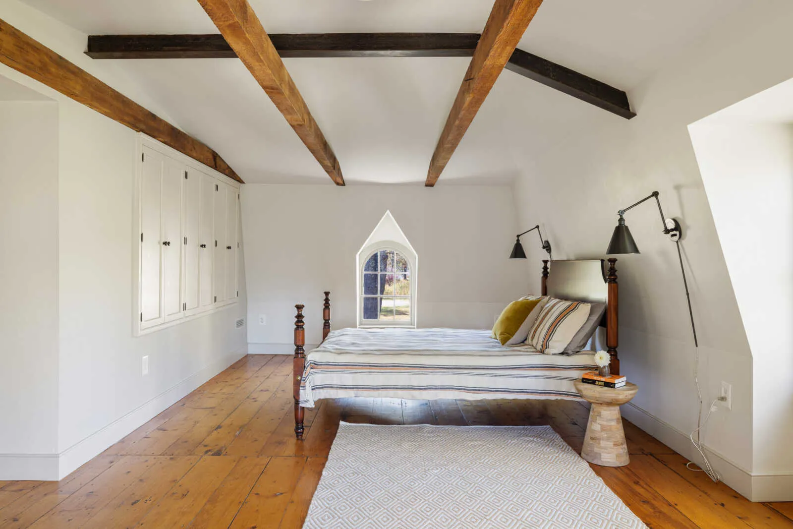 bedroom with built-in storage and exposed beams