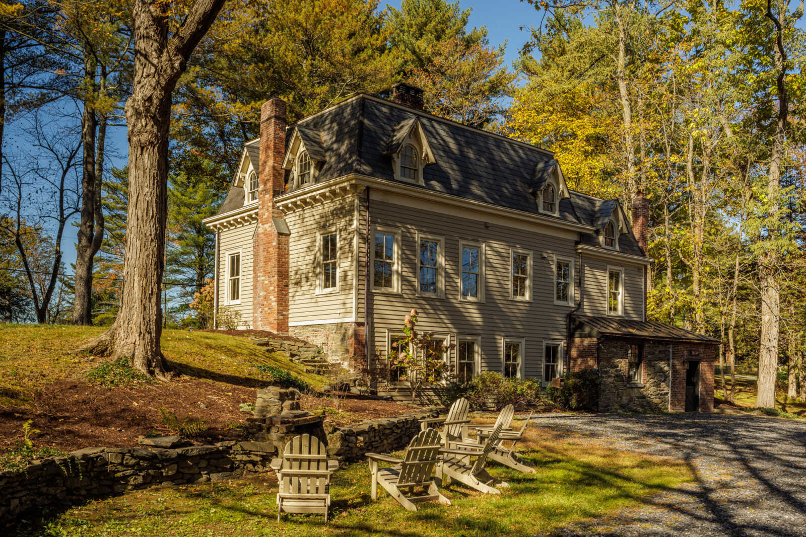 rear facade showing walk-out basement and in the yard a seating area by a fire