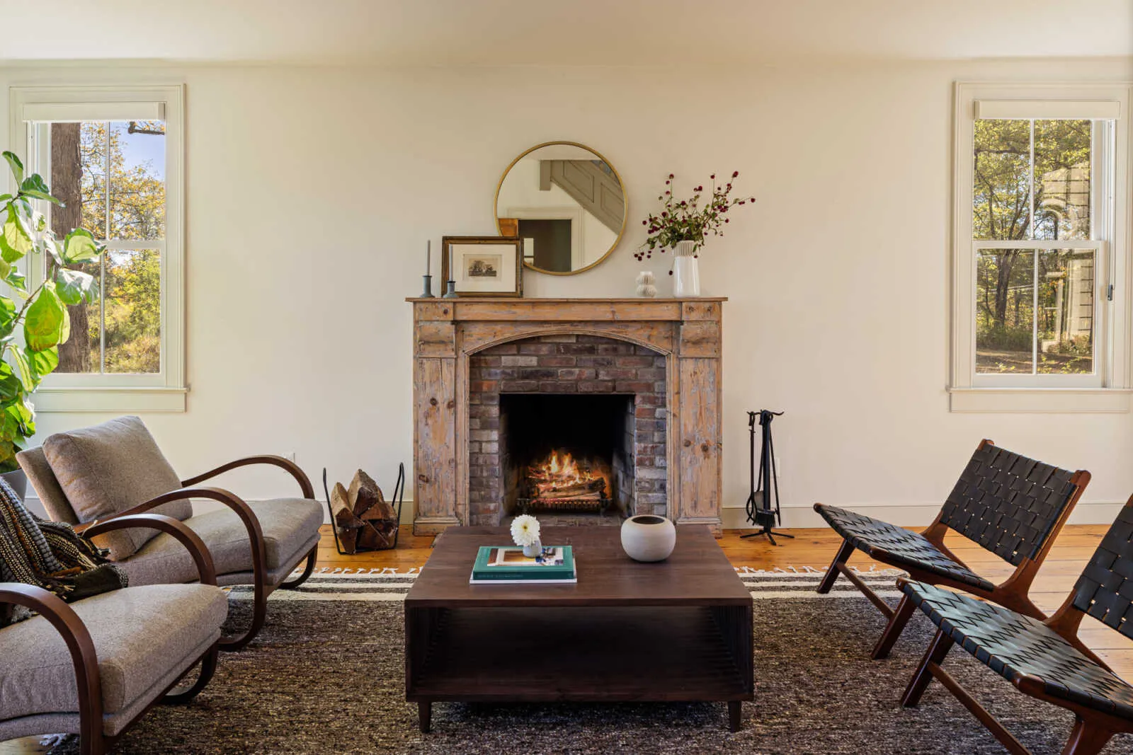 parlor with stone mantel, wide planked floorboards