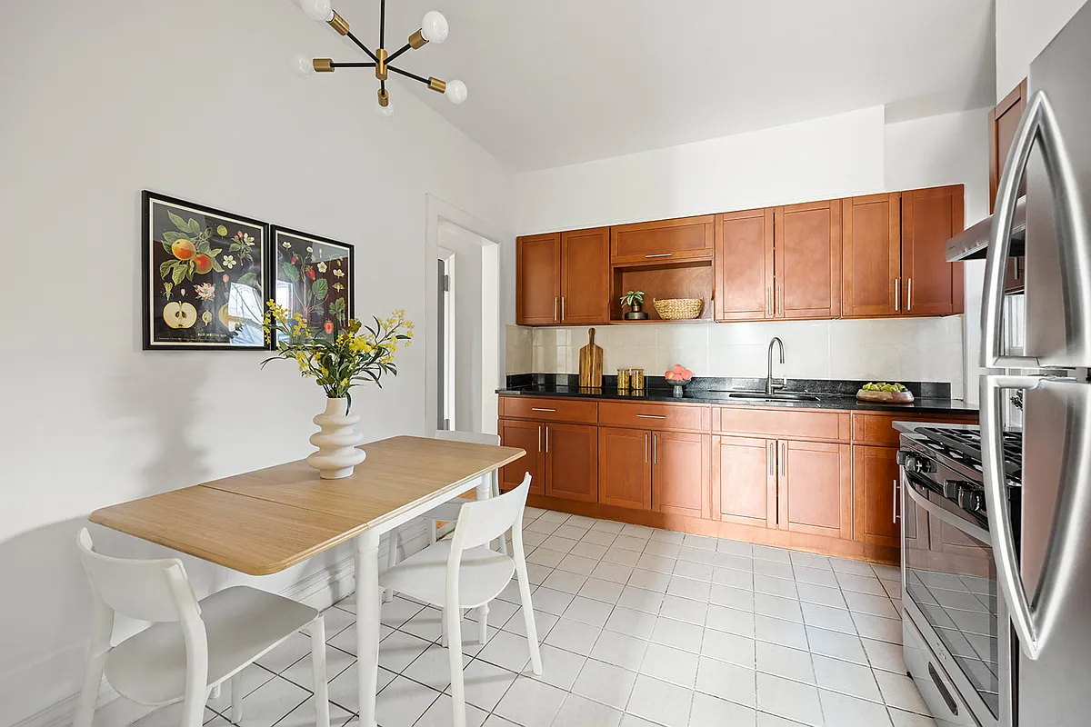 eat-in kitchen with tile floor, wood cabinets