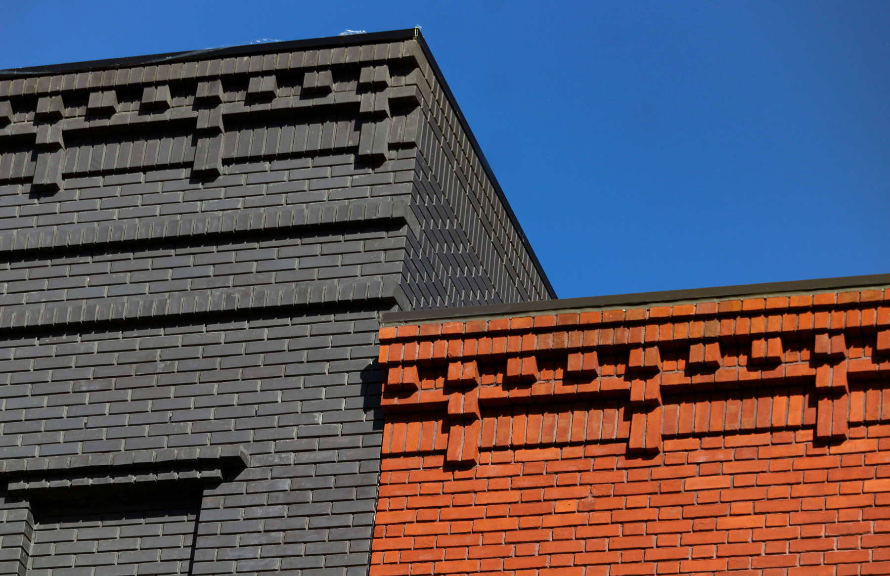 brick details on the adjoining buildings - one painted gray and the other unpainted brick