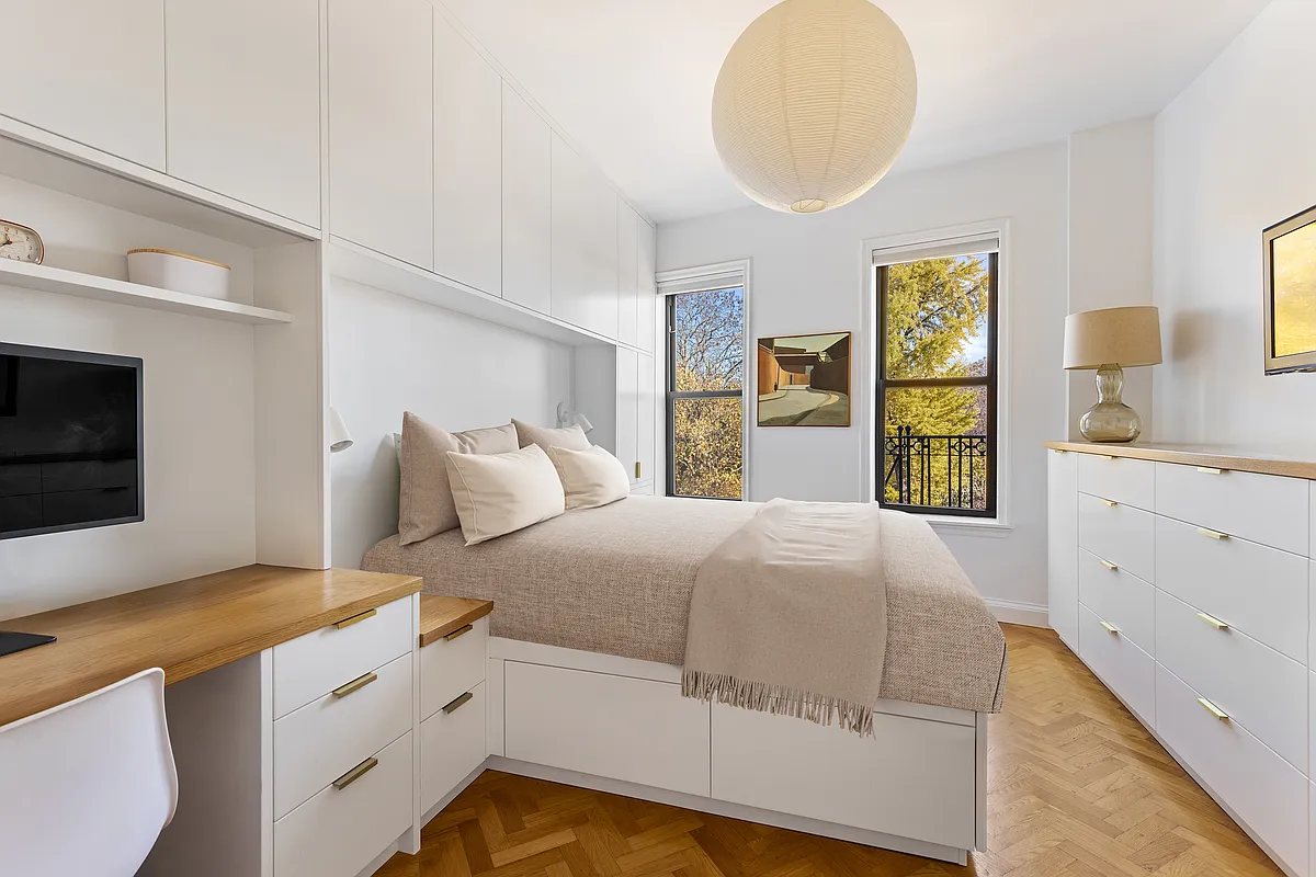 bedroom with modern built-in white cabinetry