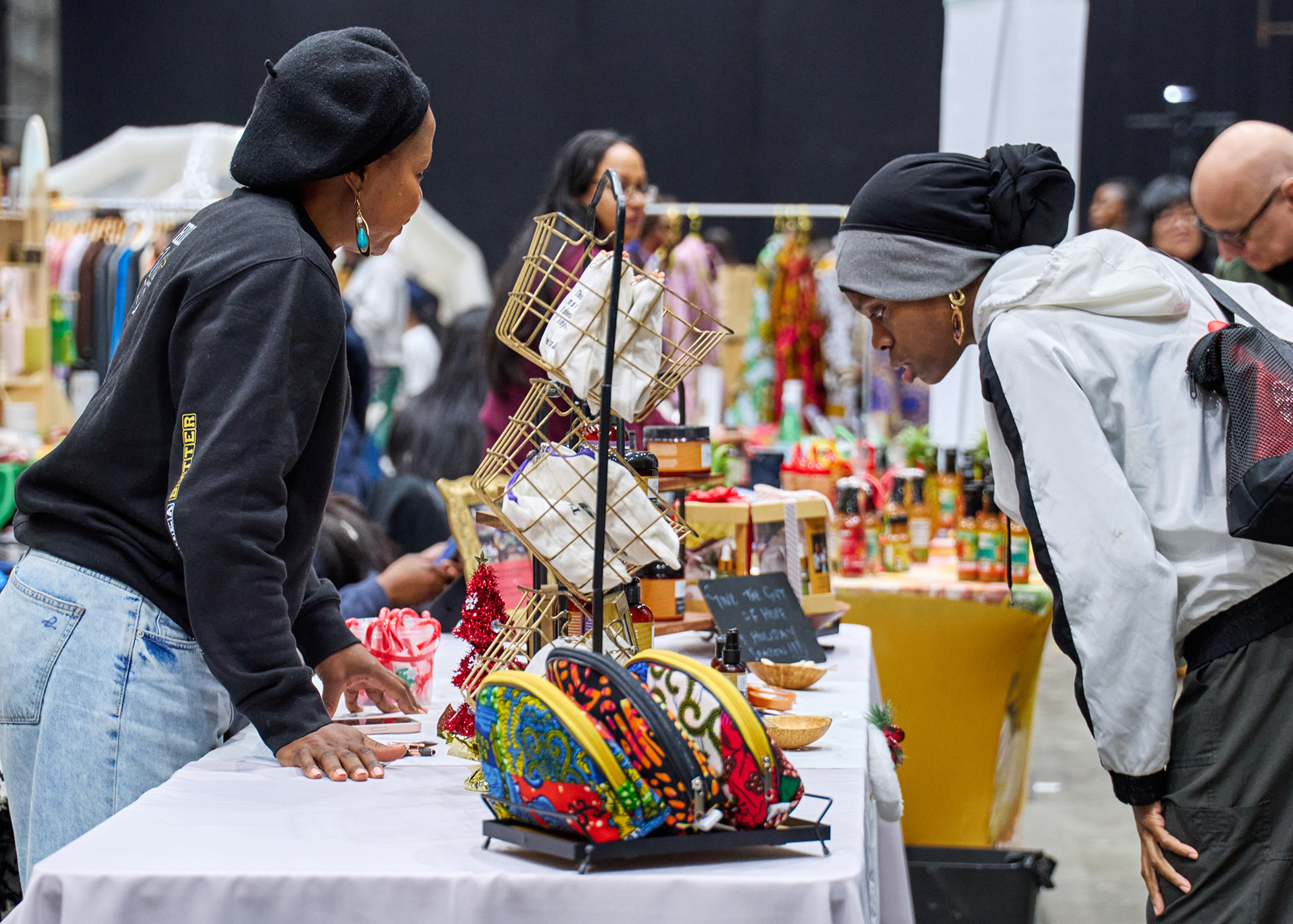 people browsing tables of goods for sale