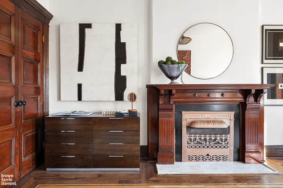 wood mantel in bedroom with modern tile hearth