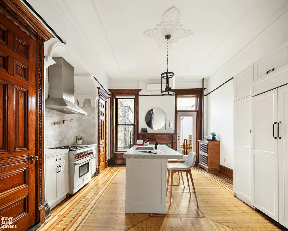 kitchen with center island, a ceiling medallion, and white cabinets