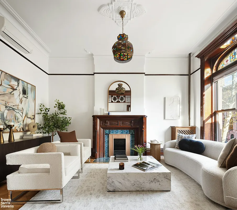 bed Stuy - a parlor with a mantel, stained glass, and a ceiling medallion