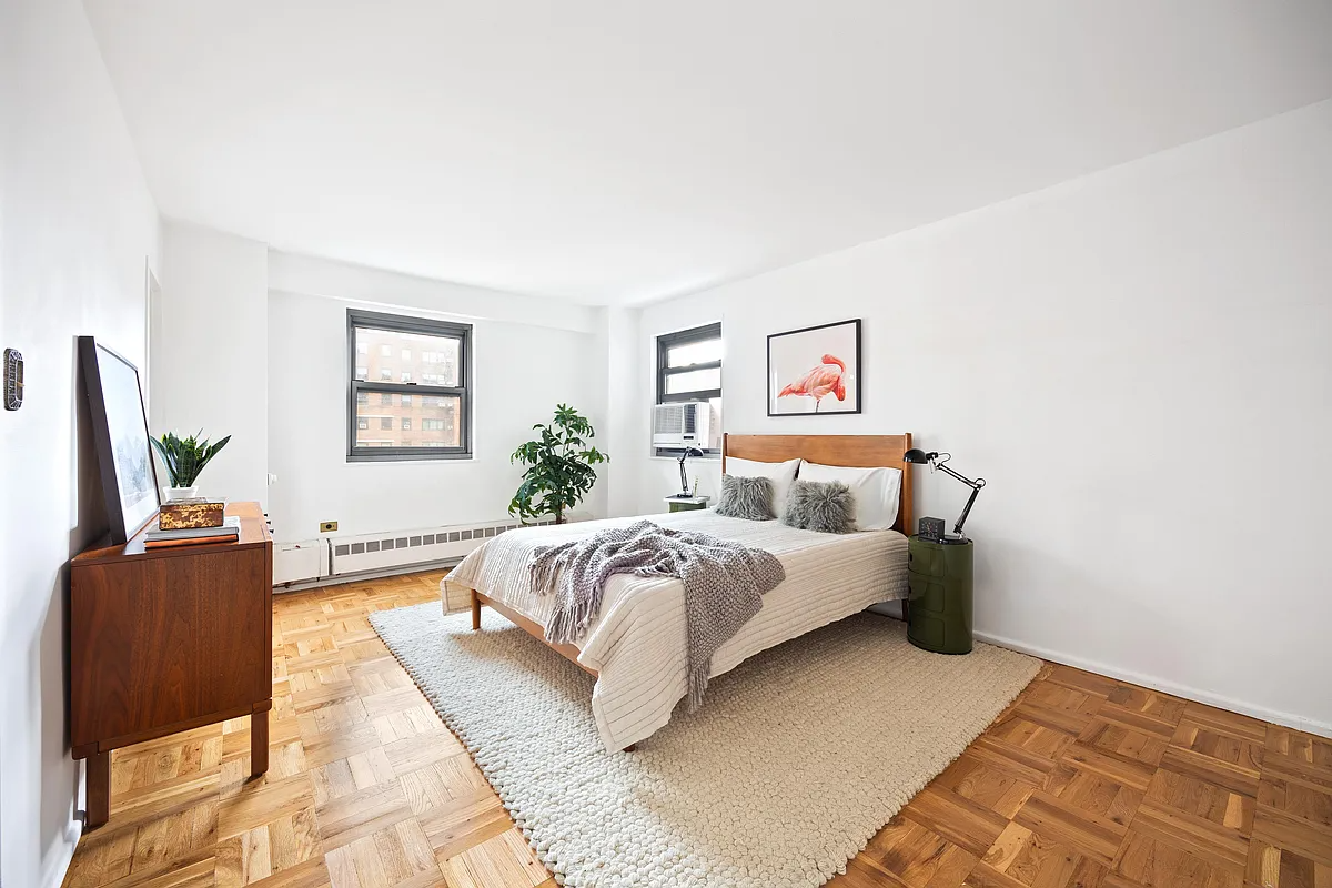 bedroom with parquet floor, baseboard heating