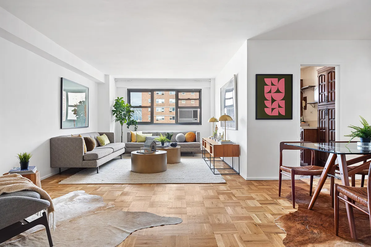 living room with parquet floor and white walls, view into kitchen