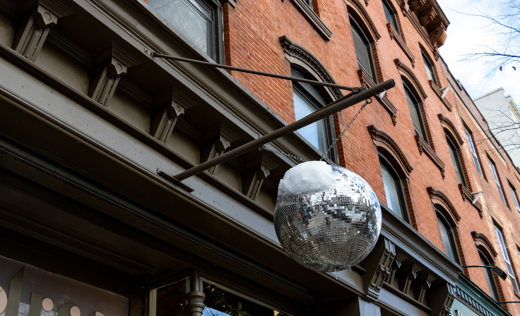 brooklyn - snow on a disco ball outside a brick building on atlantic avenue