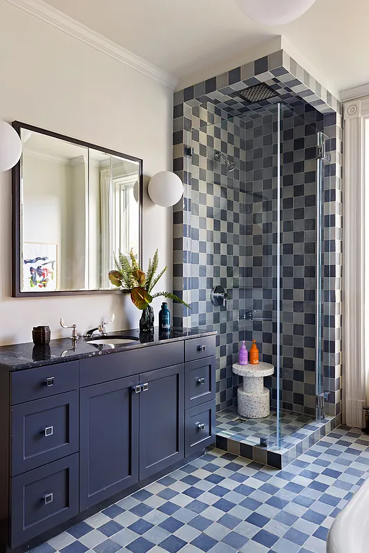 bathroom with blue checkerboard tile floor and shower surround