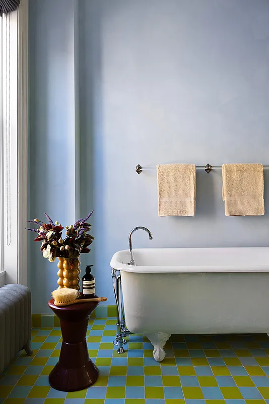 bathroom with blue and green checkerboard floor, claw foot tub