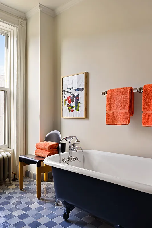 bathroom with blue checkerboard floor and a clawfoot tub