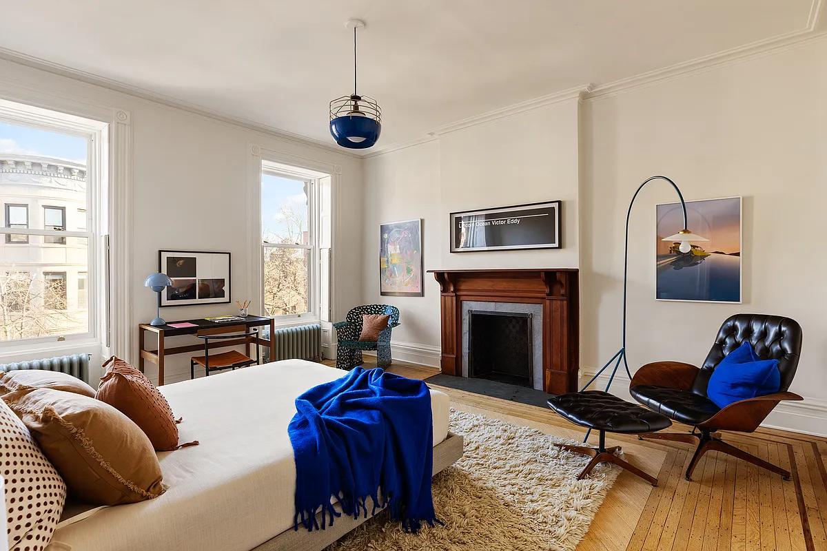 bedroom with wood floor, wood mantel