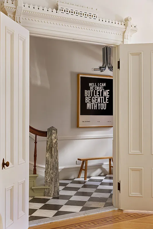 entry with checkerboard floor, modern newel post