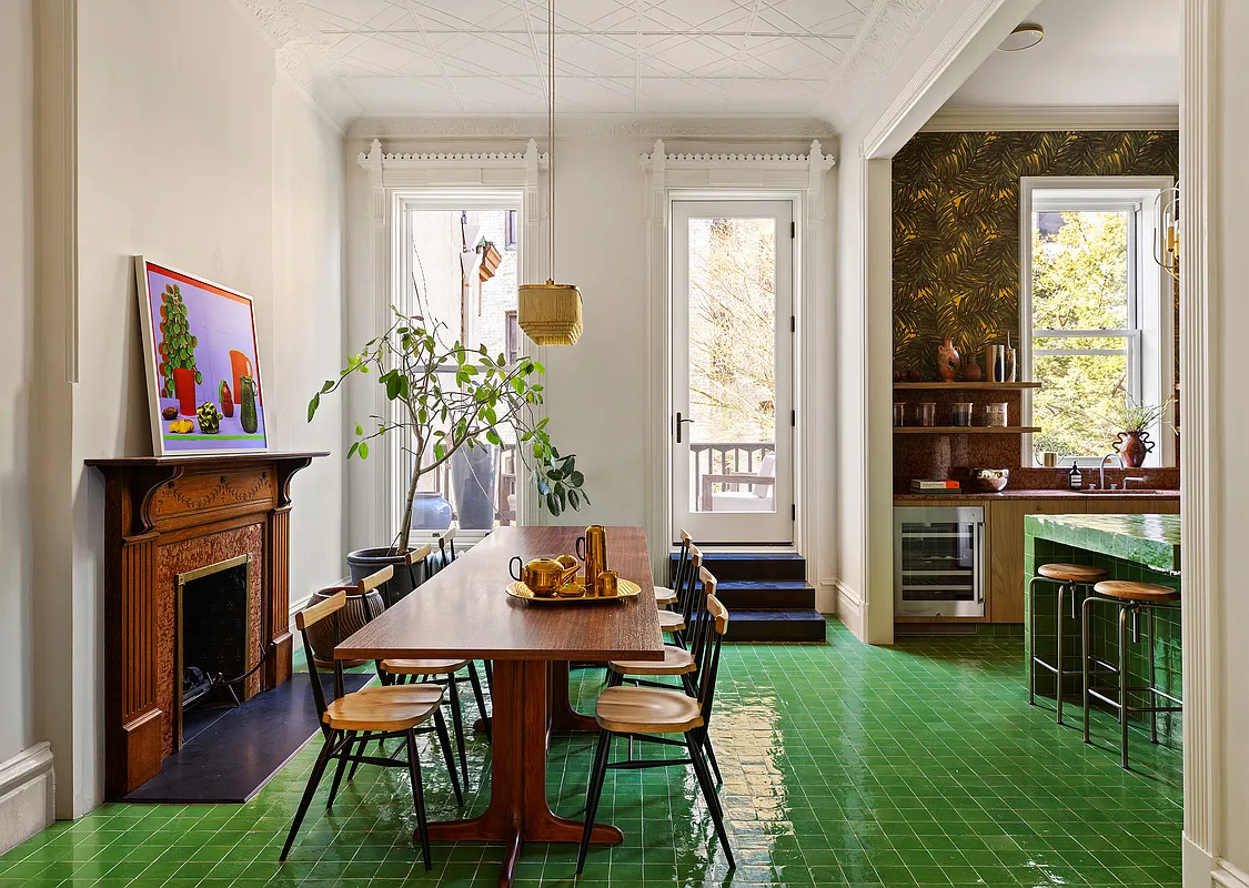 kitchen and dining area with bright green tile floor, wood mantel