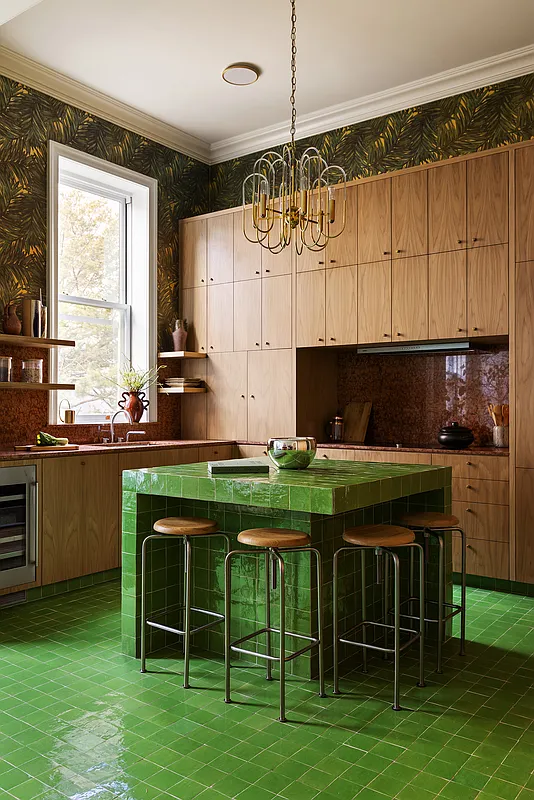 kitchen with green tile floor and island and bank of wood cabinets