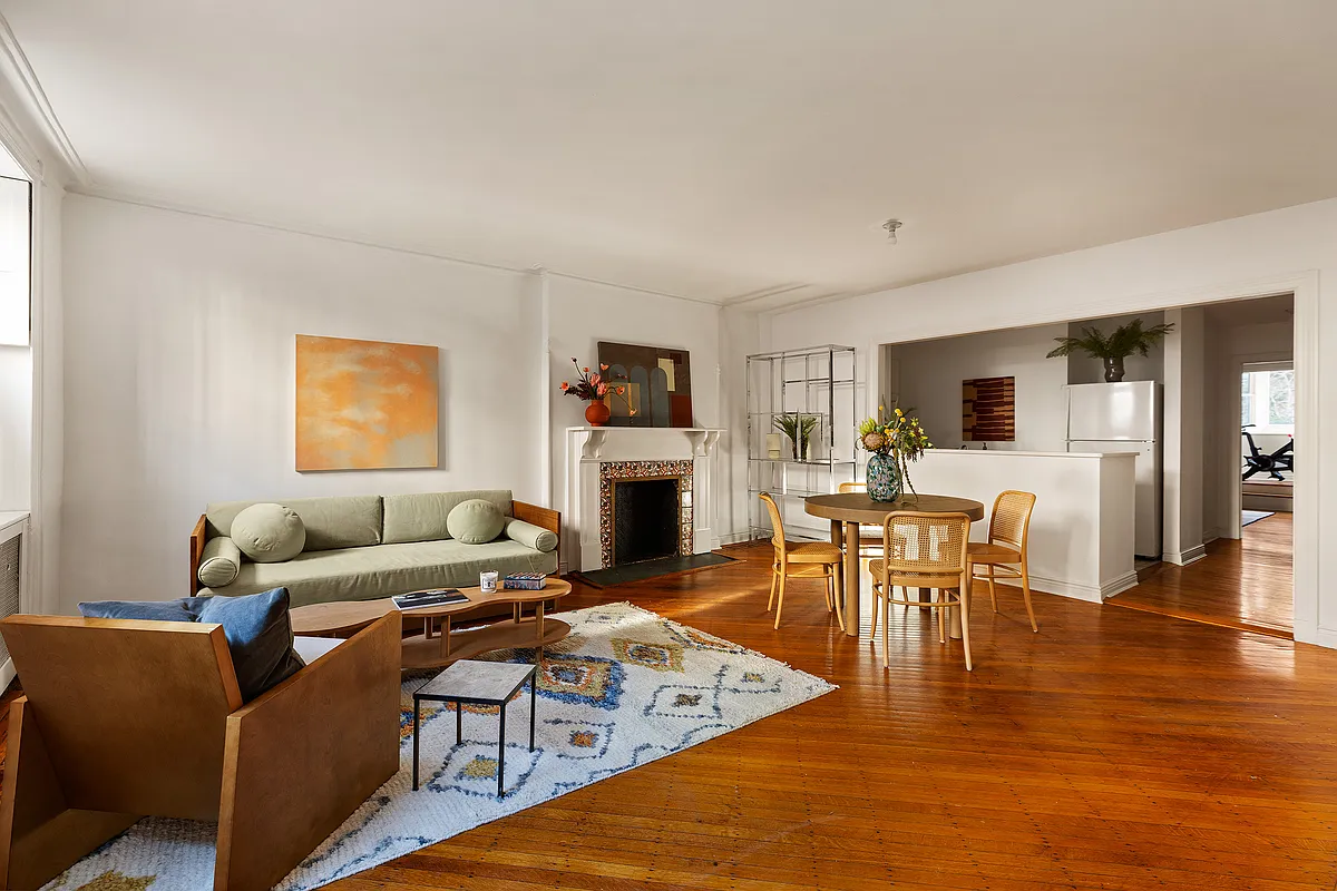 garden level living room with half wall dividing kitchen