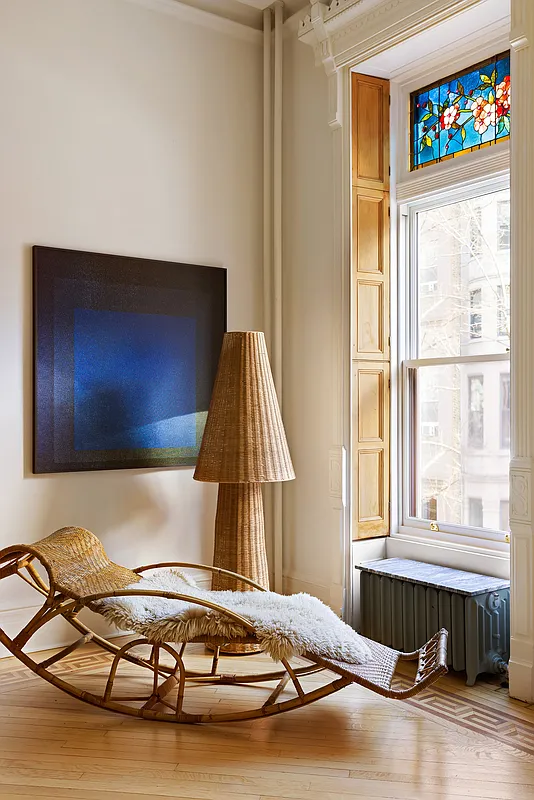 room with interior window shutters, wood floor