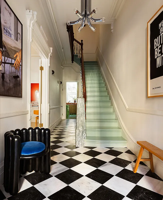 entry with checkerboard floor, pale green steps and modern stone mantel