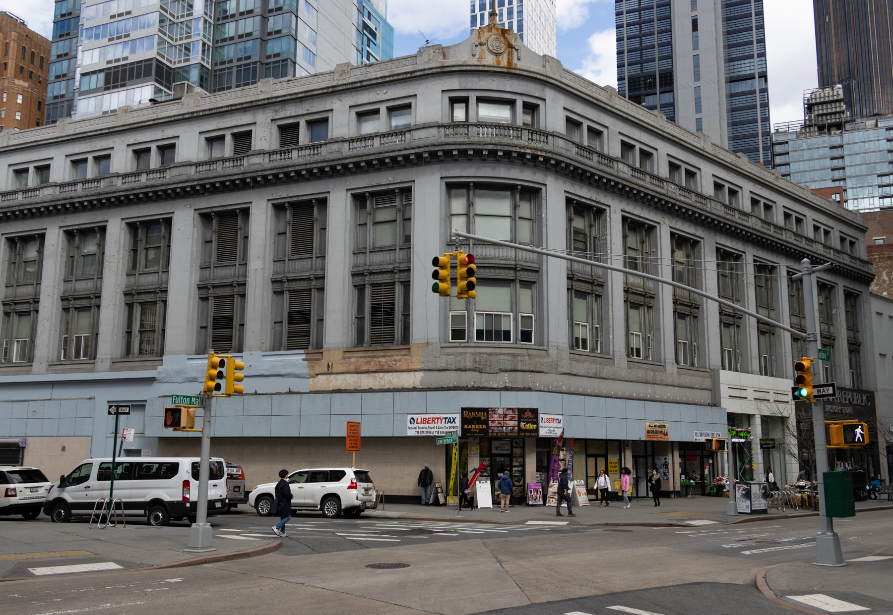 curved, corner buidling with commercial storefronts