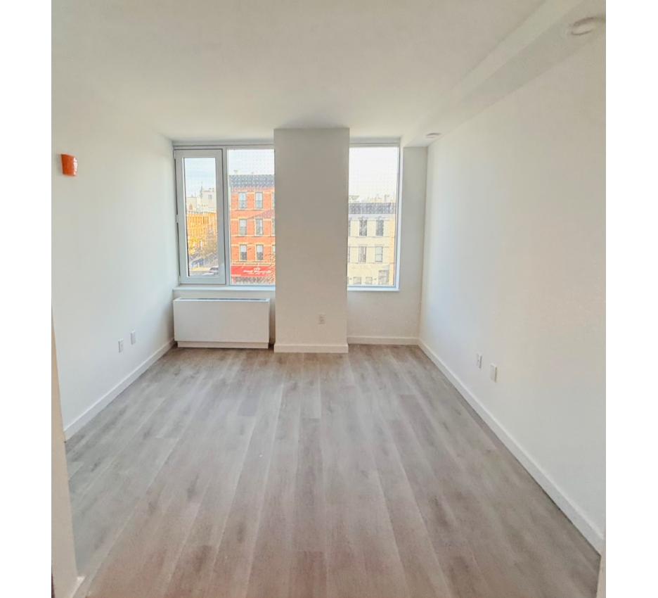 room with pale floor and white walls