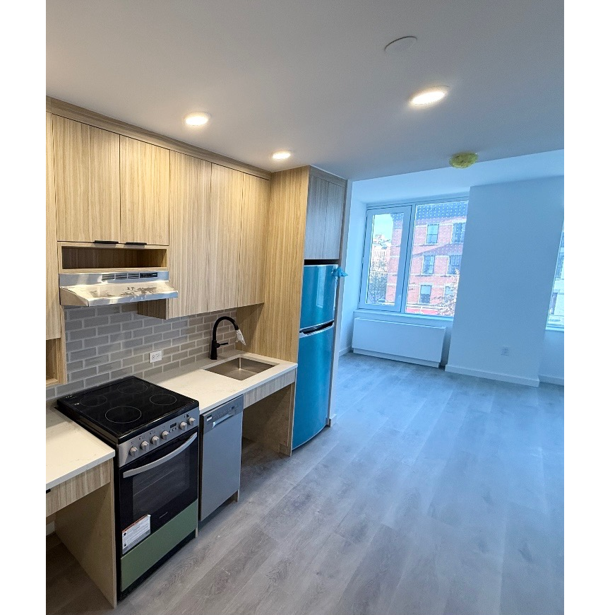 kitchen with pale cabinets, gray tile backsplash