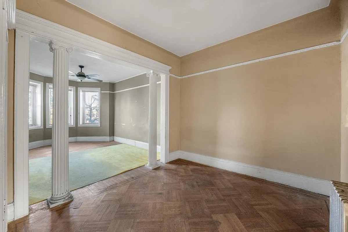 parlor with columns, wood floor