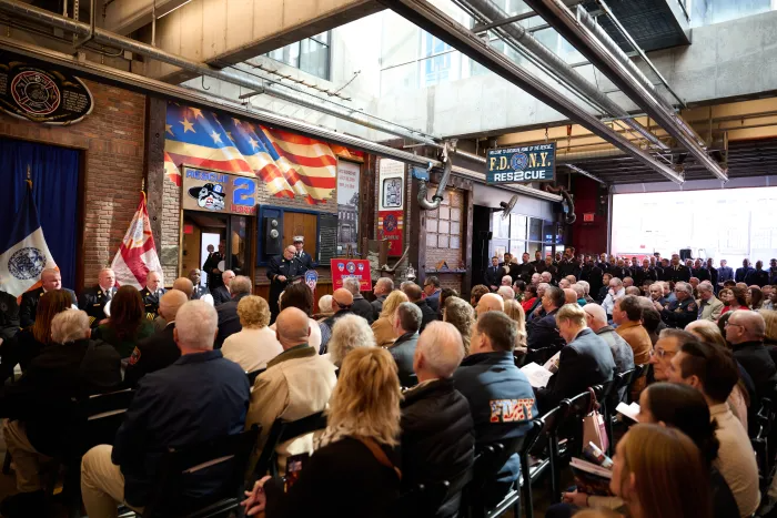 people sitting inside the station for the ceremony