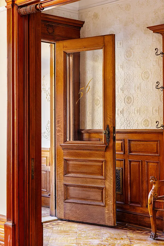 entry with original door, wainscoting, lincrusta