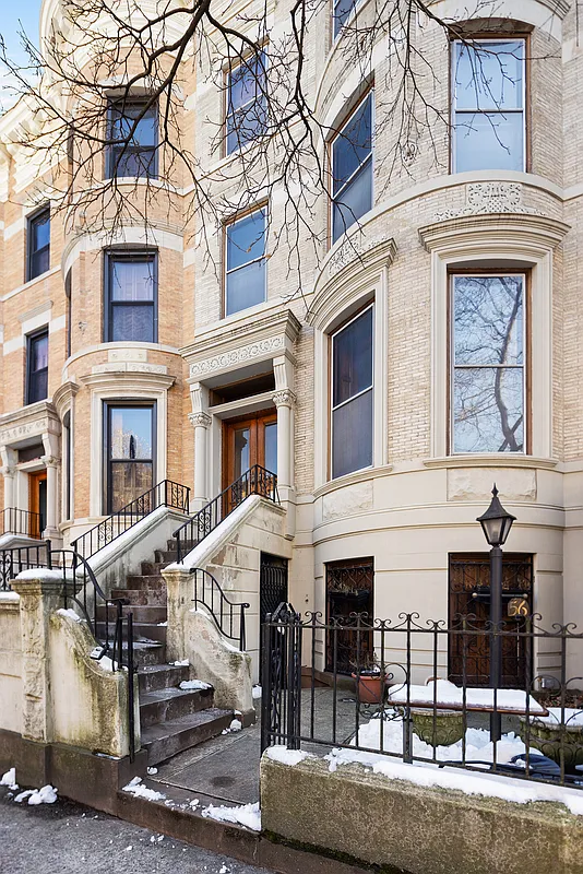 pale brick exterior of the bow front row house