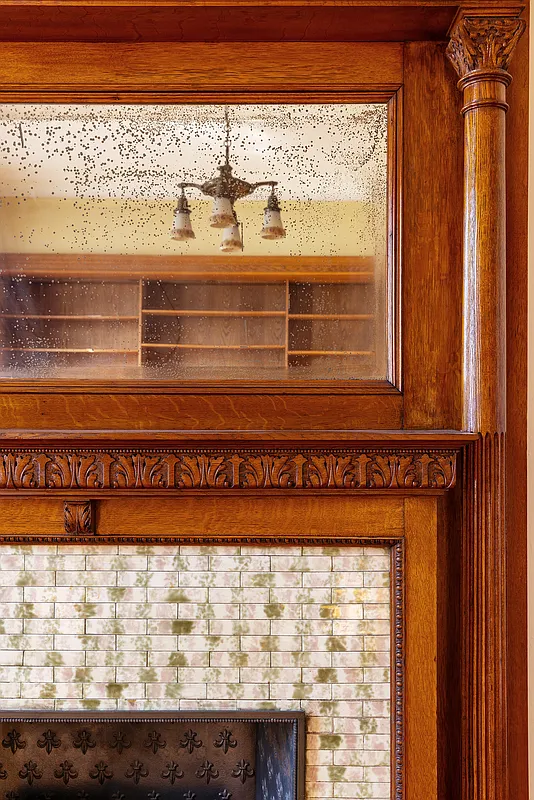 mantel detail showing original tilework on rear parlor mantel