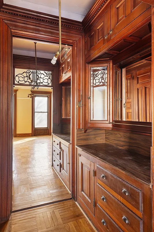 passthrough between bedrooms with original cabinets but no sinks